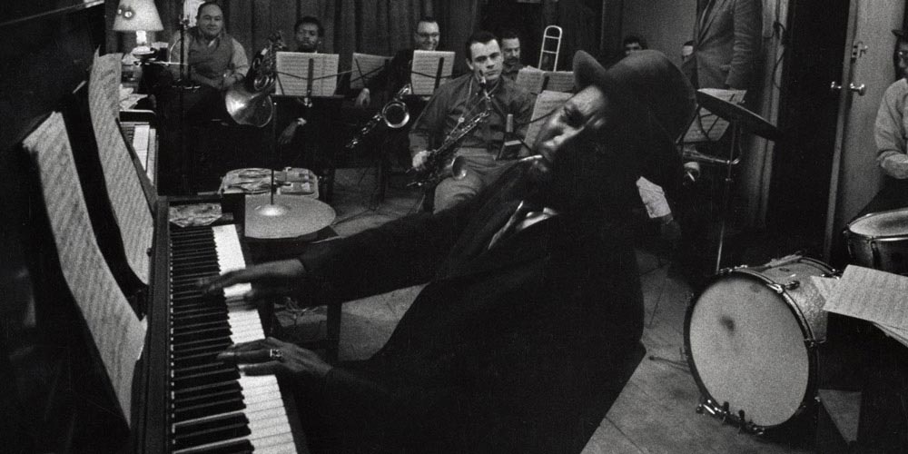 Thelonious Monk playing the piano in a rehersal studio