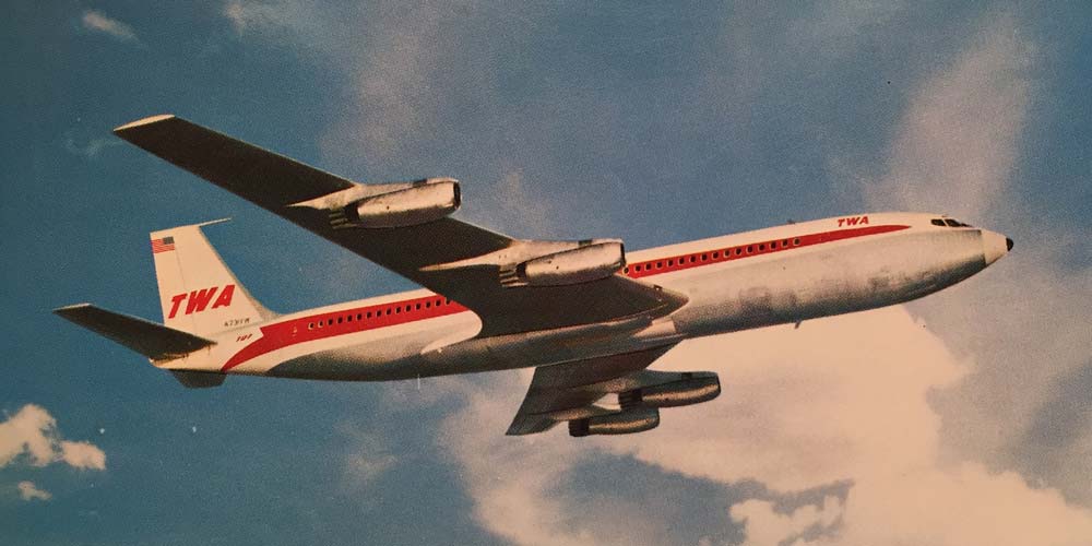 a TWA airlines plane flying in the sky